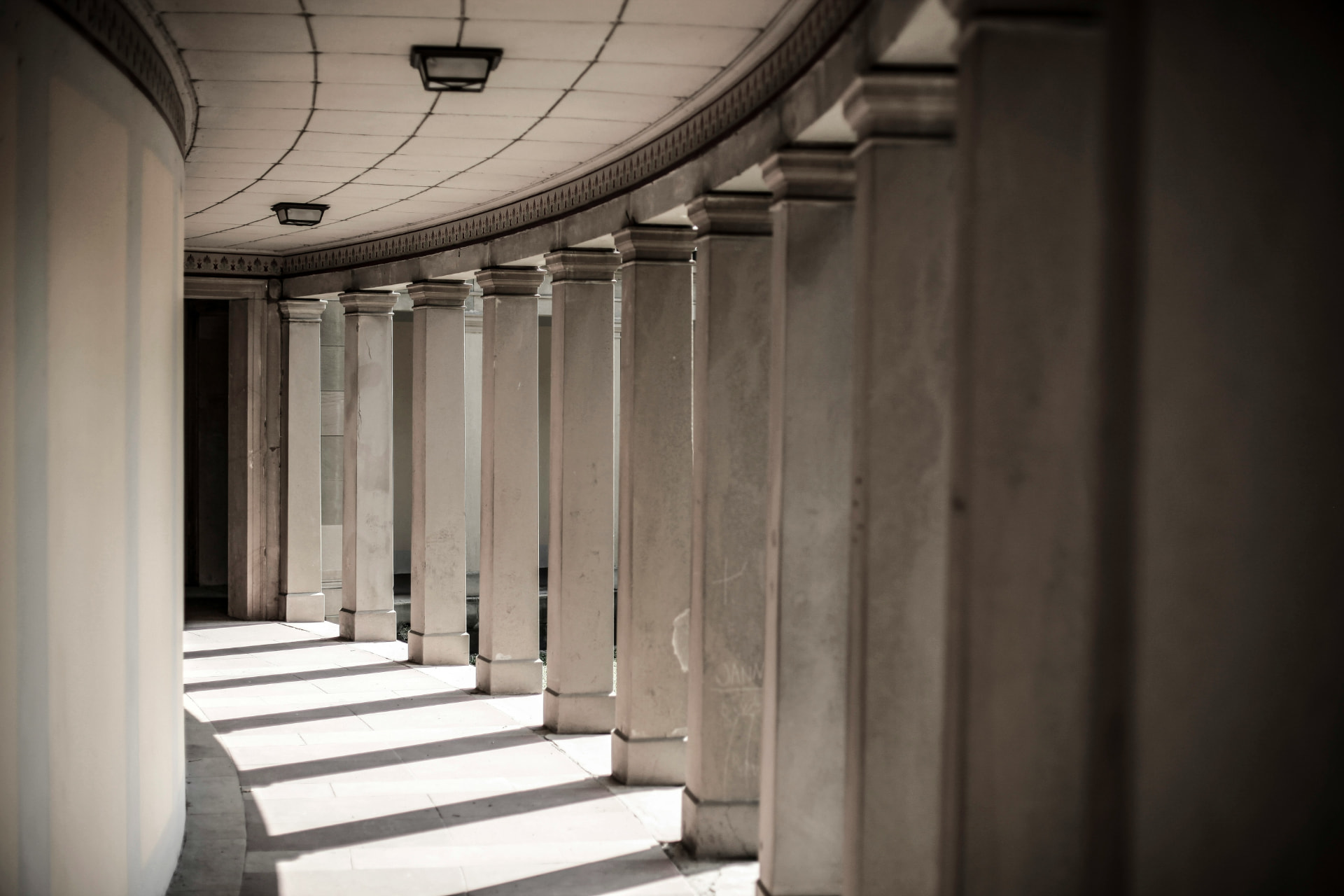 Classical stone colonnade with warm light and shadow